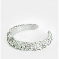 Silver ring with gemstone accents on a white background