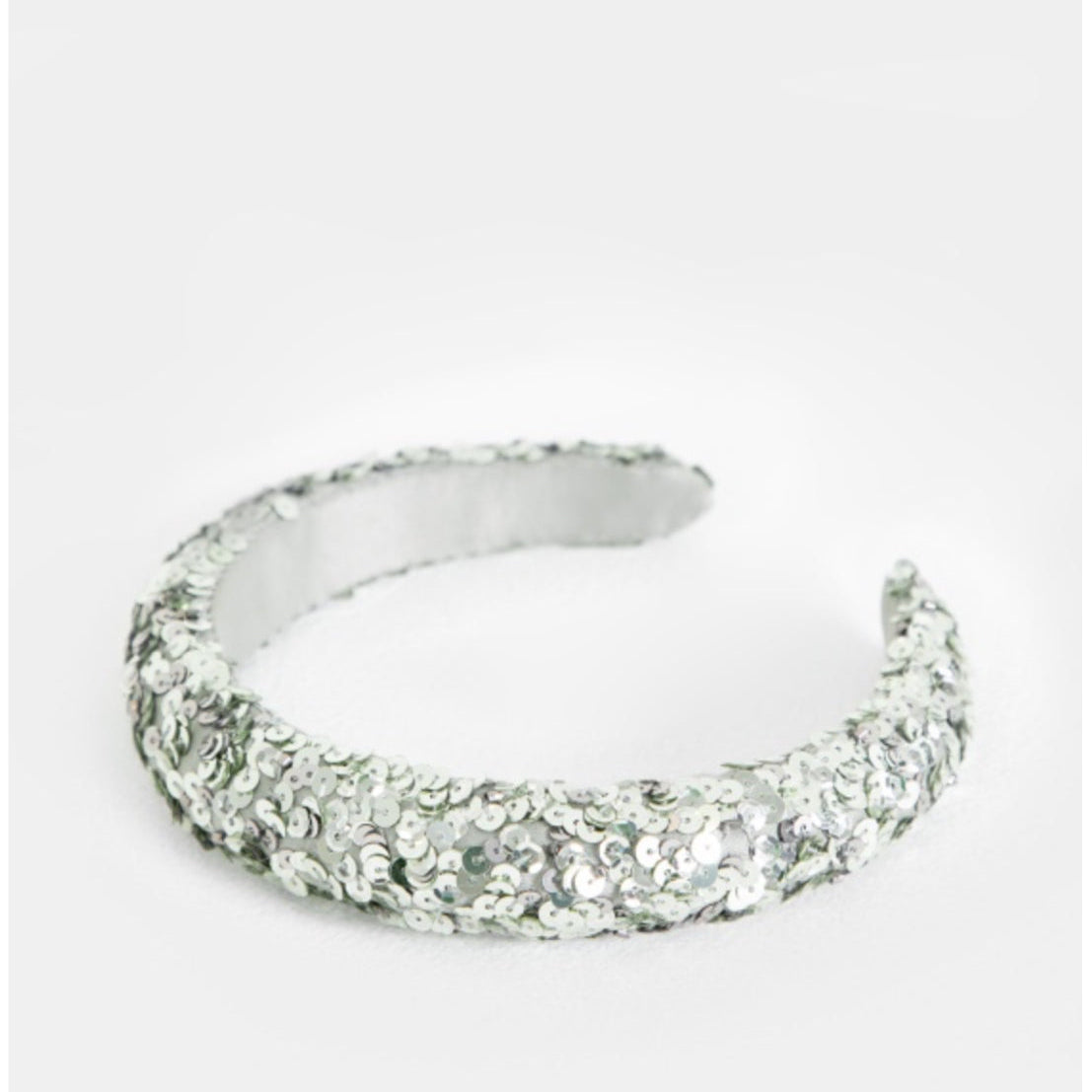 Silver ring with gemstone accents on a white background